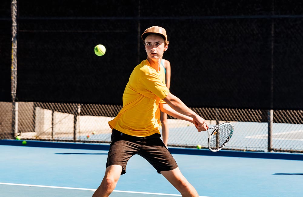 kid playing tennis